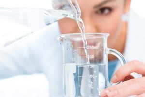 Scientist Pouring Chemical Liquid Into Laboratory 2023 11 27 05 04 22 Utc - Aqua Plus